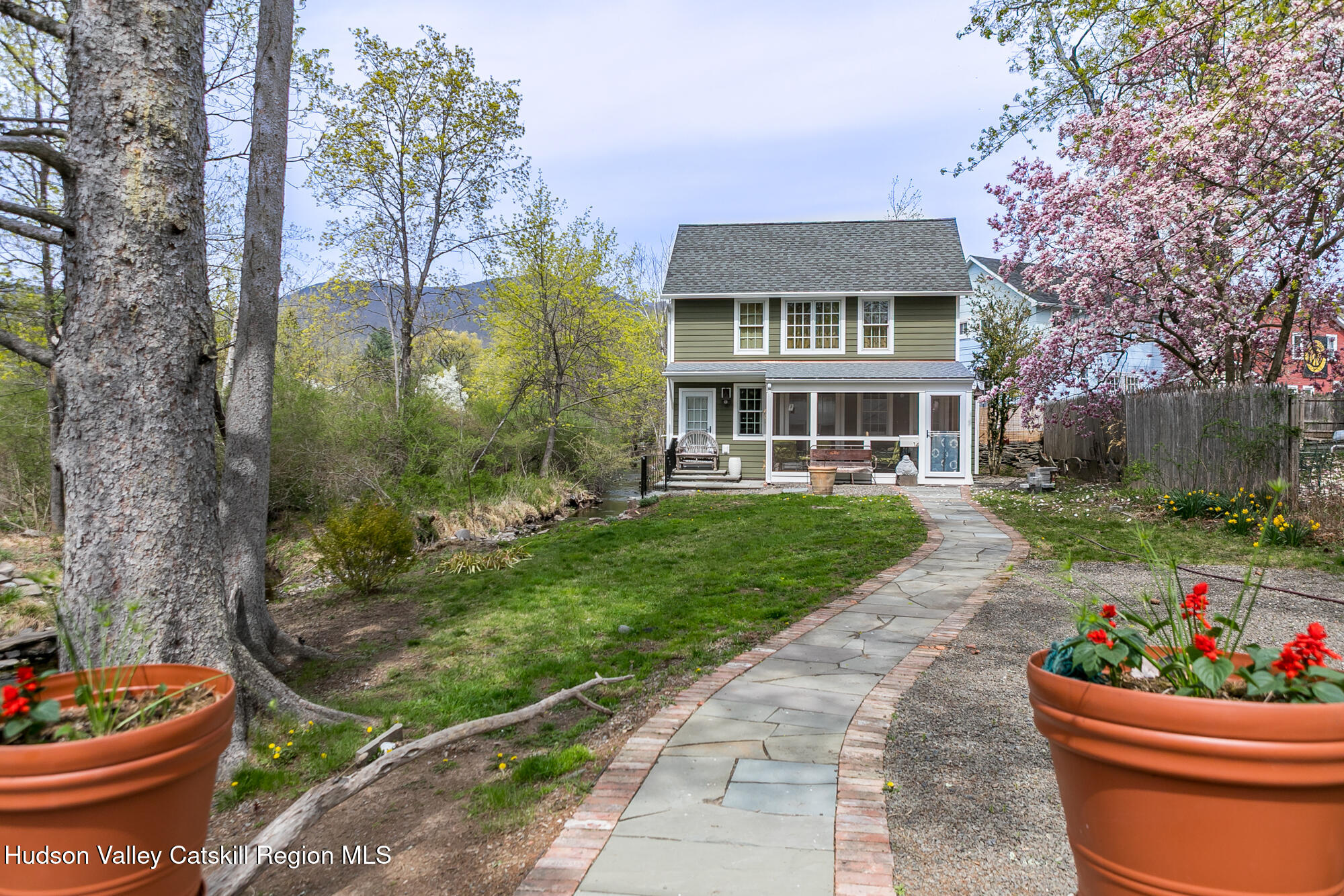 14 Old Forge Road Woodstock, NY 12498 - Photo 27 of 29 a front view of a house with a yard and potted plants