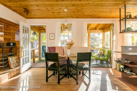 a view of a dining room with furniture and a window