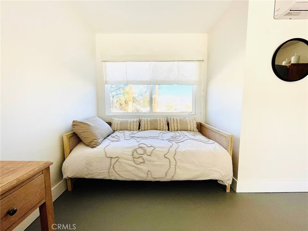 83683 Amboy Road Twentynine Palms, CA 92277 - Photo 14 of 22 a bedroom with a bed and a window