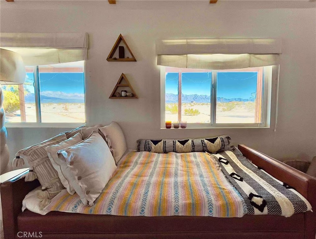 83683 Amboy Road Twentynine Palms, CA 92277 - Photo 15 of 22 a bedroom with a bed and window