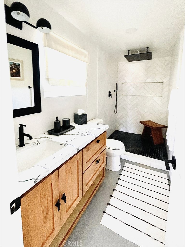 83683 Amboy Road Twentynine Palms, CA 92277 - Photo 17 of 22 a bathroom with a sink a toilet and mirror