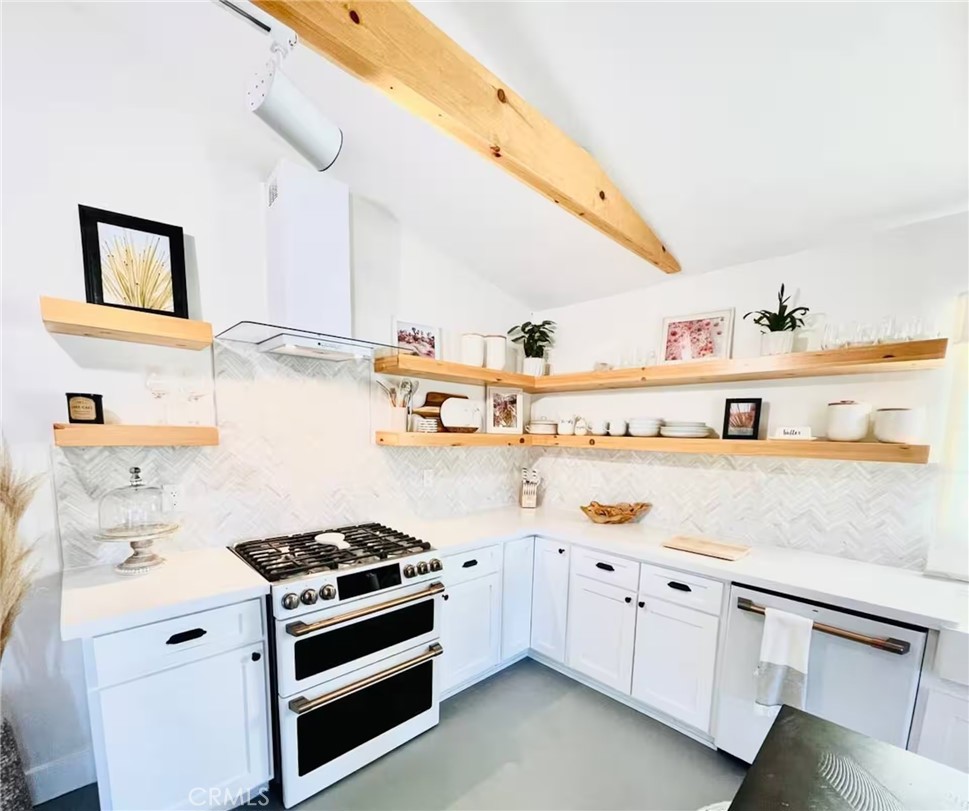 83683 Amboy Road Twentynine Palms, CA 92277 - Photo 10 of 22 a kitchen with kitchen island white cabinets and white appliances