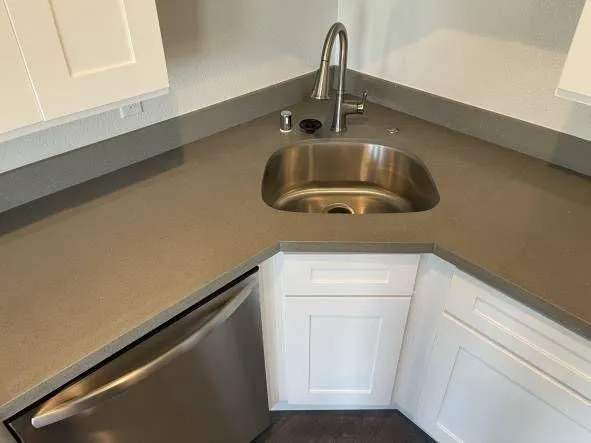 a close view of sink and dishwasher in kitchen