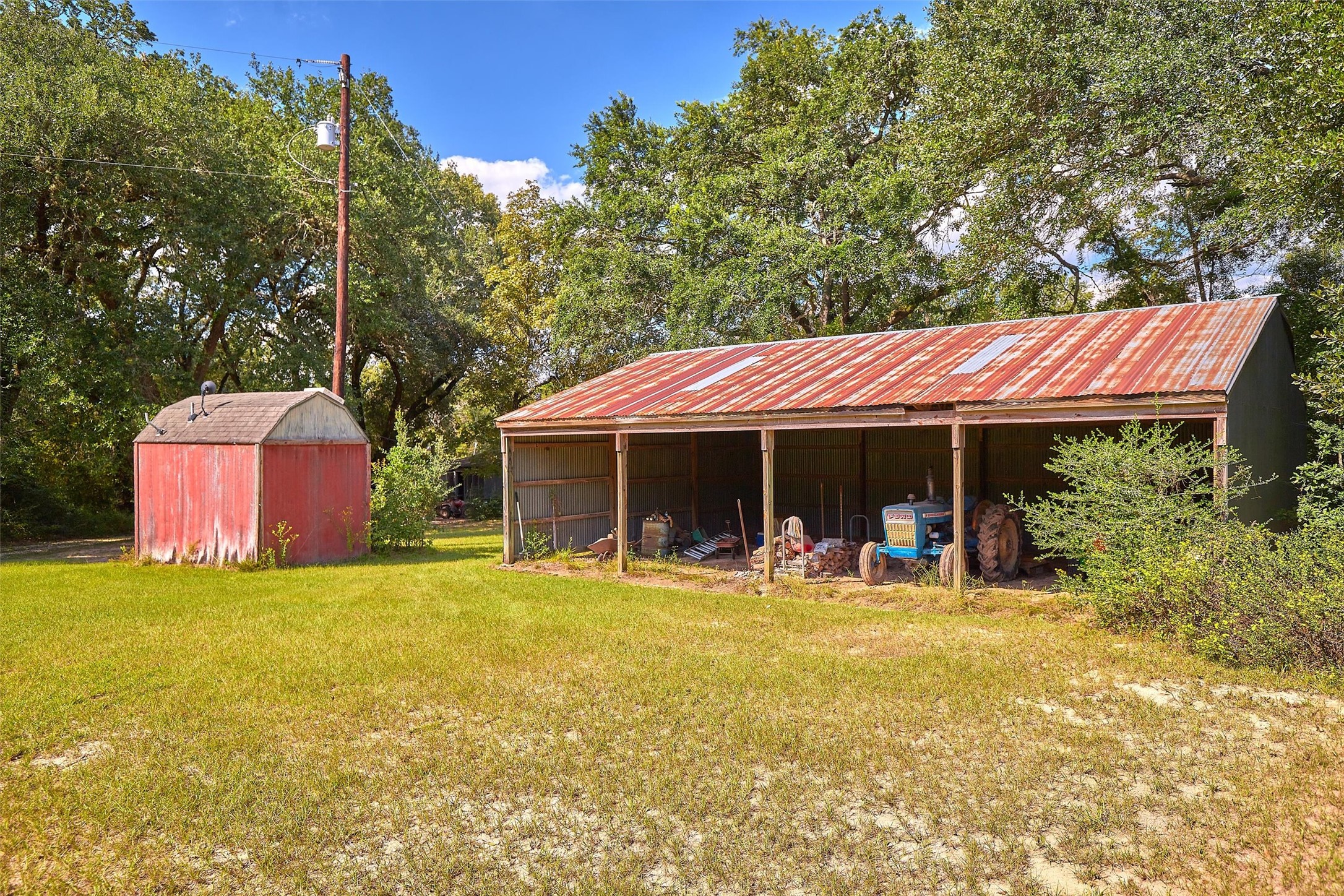 24030 Hegar Road Hockley, TX 77447 - Photo 8 of 40 This close-up view showcases the barn and shed, perfectly suited for equipment, tools, or additional storage. Conveniently located on the property, these structures add practical value and functionality for ranching or recreational use.