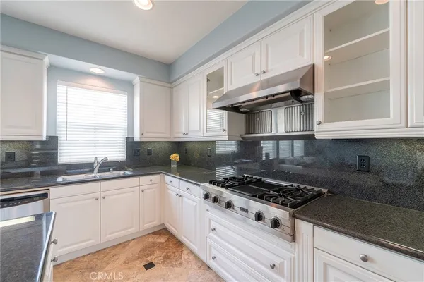a kitchen with cabinets and stainless steel appliances