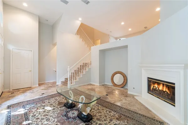 a living room with furniture and a rug