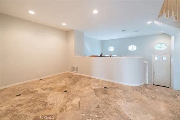 a view of a room with wooden floor