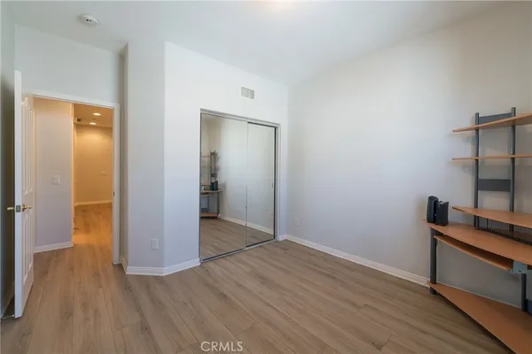 a view of room with window and wooden floor
