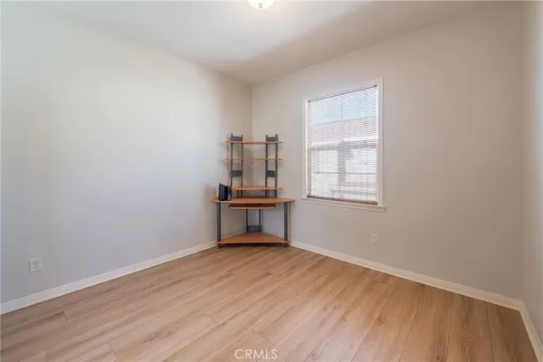 an empty room with wooden floor and closet