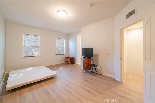 a bathroom with a bathtub a double vanity sink and mirror