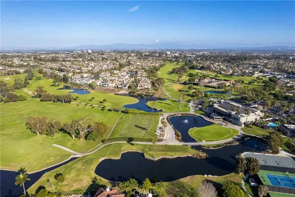 an aerial view of residential houses with outdoor space and swimming pool