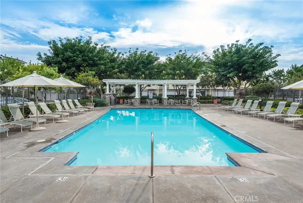 swimming pool view with a seating space and garden view