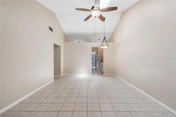 a view of a livingroom with a ceiling fan and window