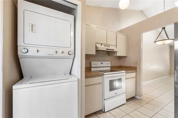 a view of washer and dryer with kitchen in the background