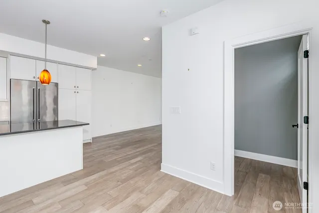 a kitchen that has a sink a stove and a wooden floor