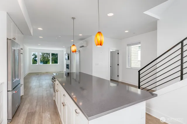 a view of a livingroom with a fireplace wooden floor and window