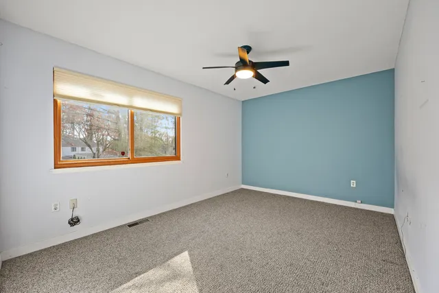 a view of room with a ceiling fan and window