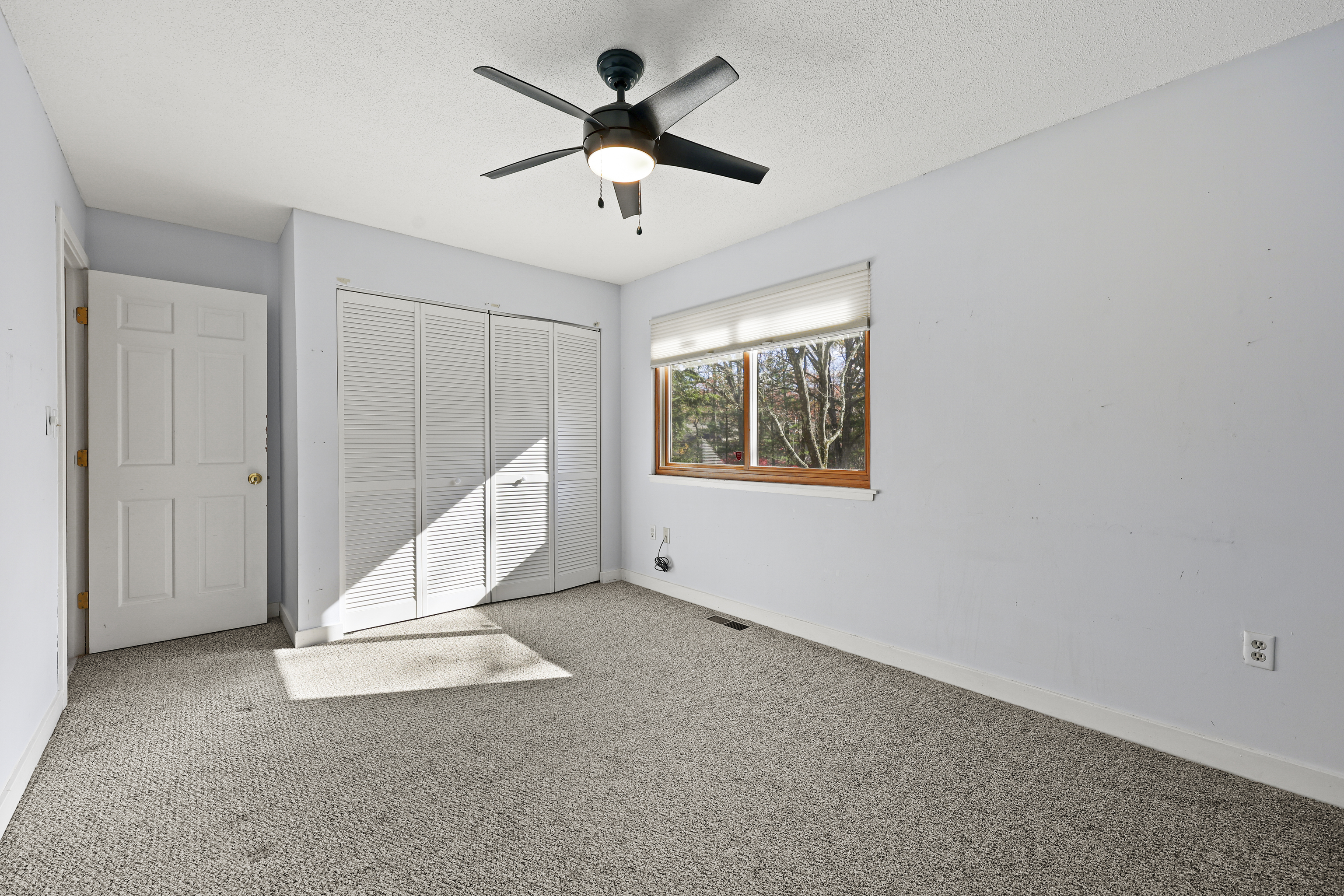 27 Farmington Chase Crescent Farmington, CT 06032 - Photo 16 of 39 an empty room with a ceiling fan and windows