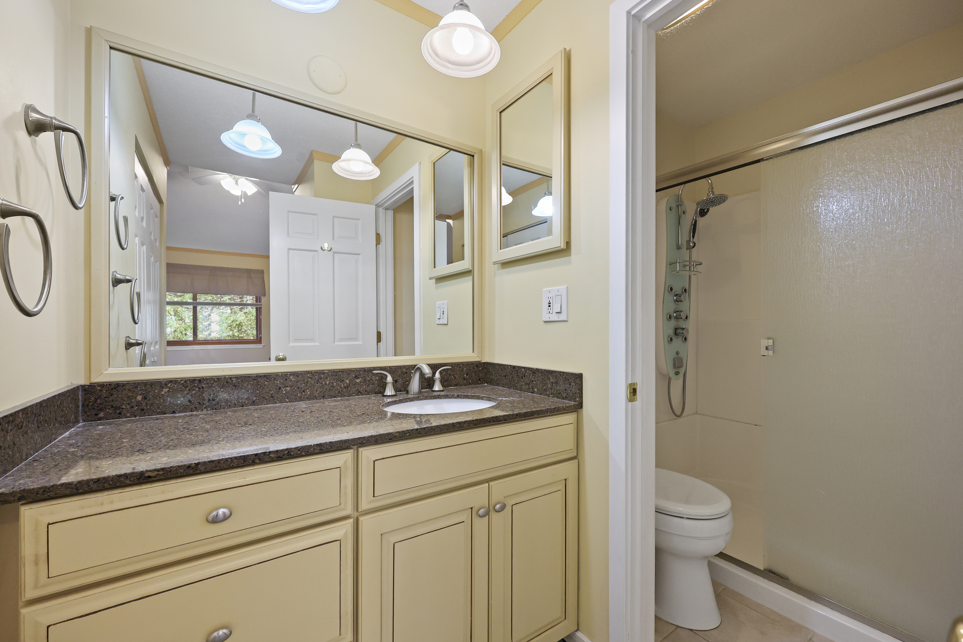 27 Farmington Chase Crescent Farmington, CT 06032 - Photo 22 of 39 a bathroom with a granite countertop sink a toilet and a mirror