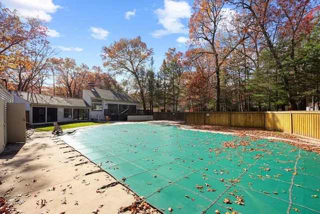 a view of backyard with swimming pool