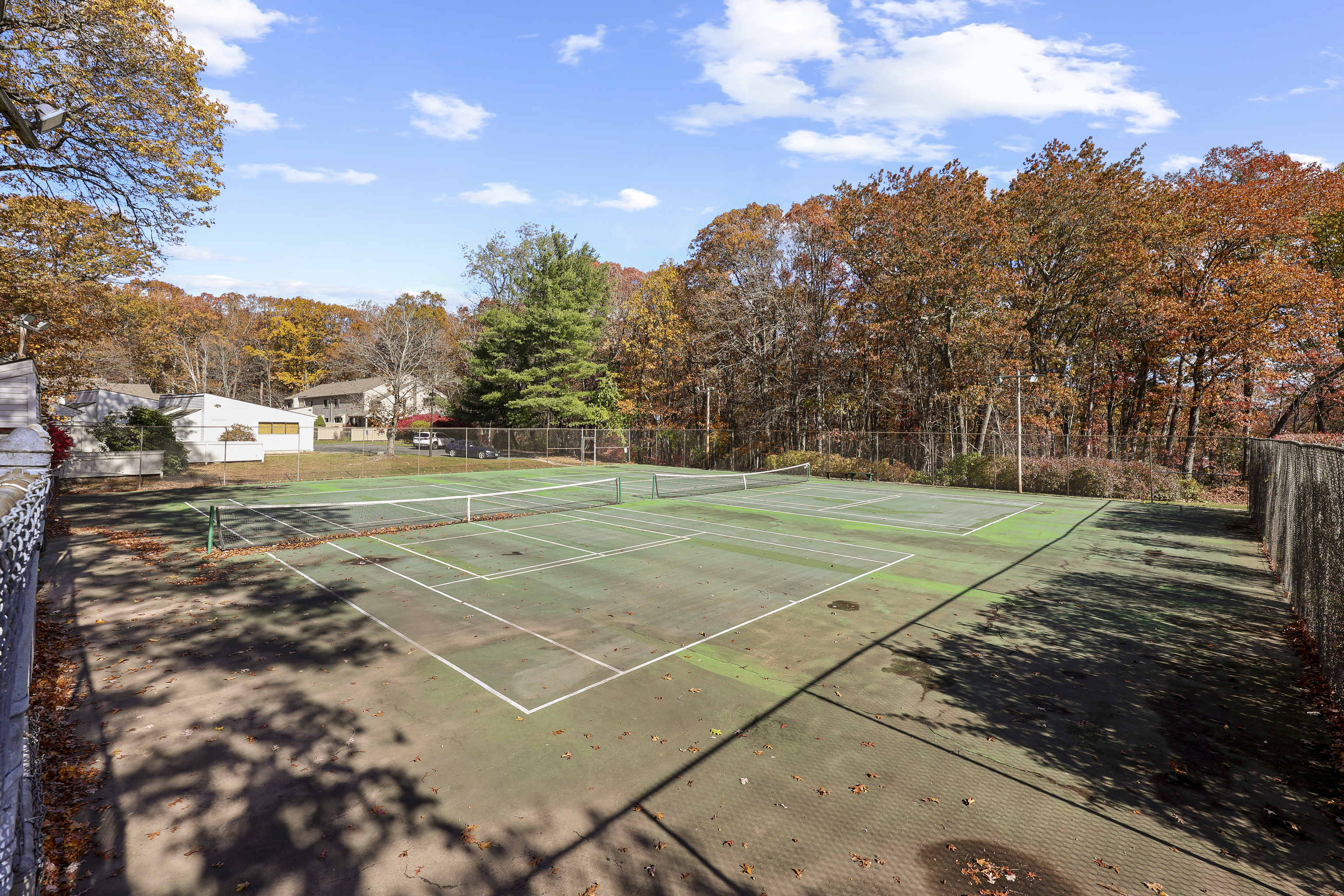 27 Farmington Chase Crescent Farmington, CT 06032 - Photo 32 of 39 a view of a tennis ground with large trees