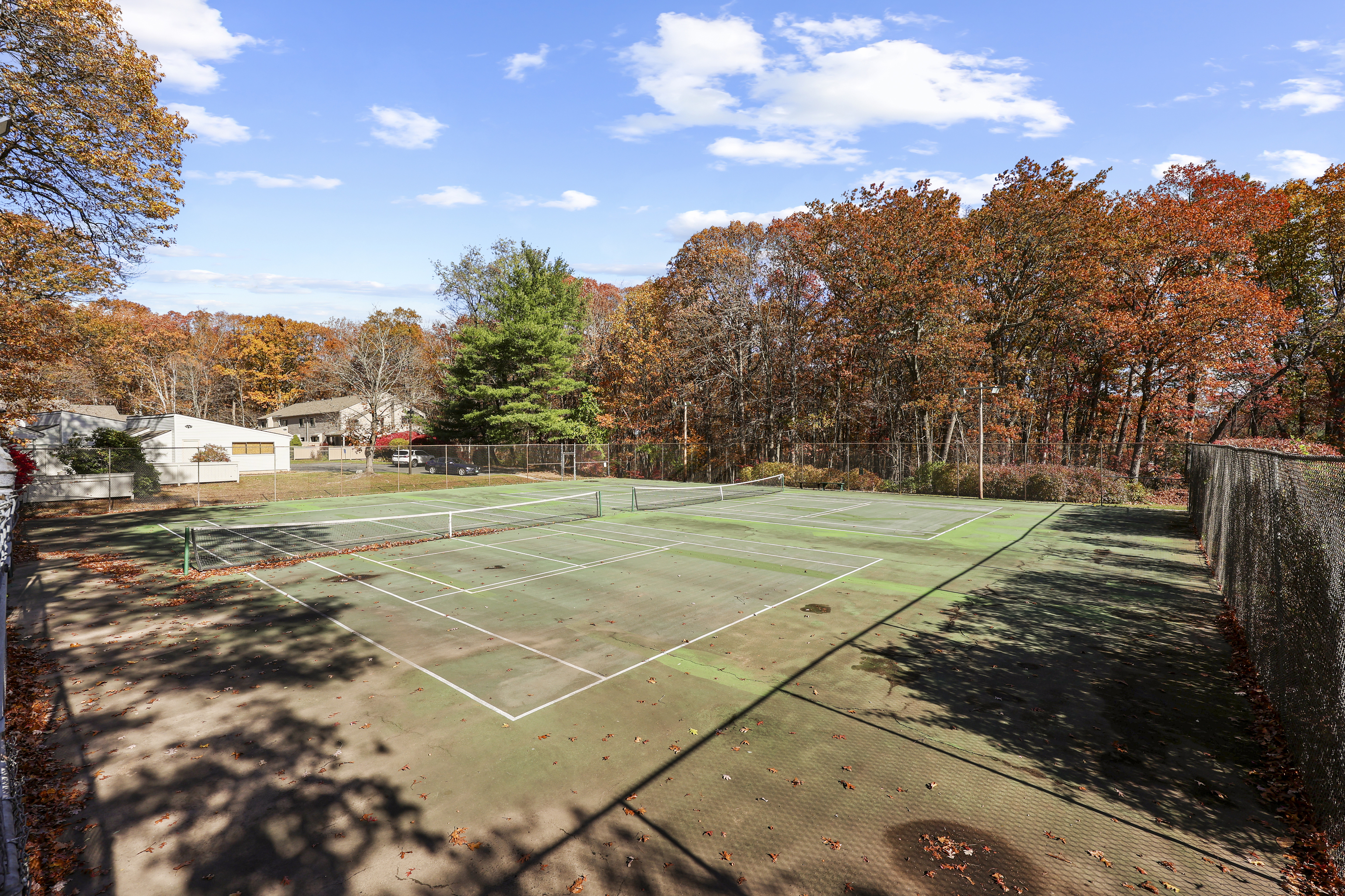 27 Farmington Chase Crescent Farmington, CT 06032 - Photo 36 of 39 a view of a tennis ground with large trees