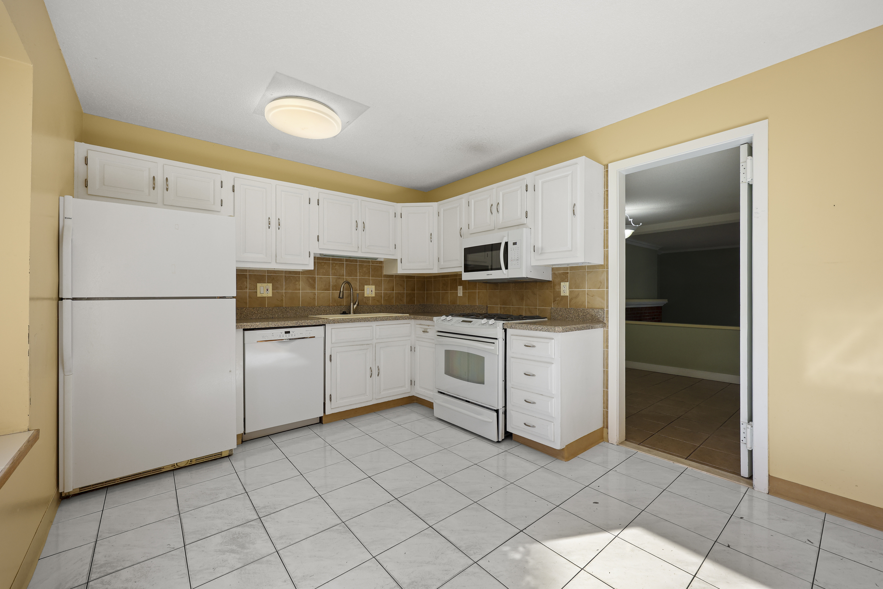 27 Farmington Chase Crescent Farmington, CT 06032 - Photo 10 of 39 a kitchen with white cabinets and white appliances