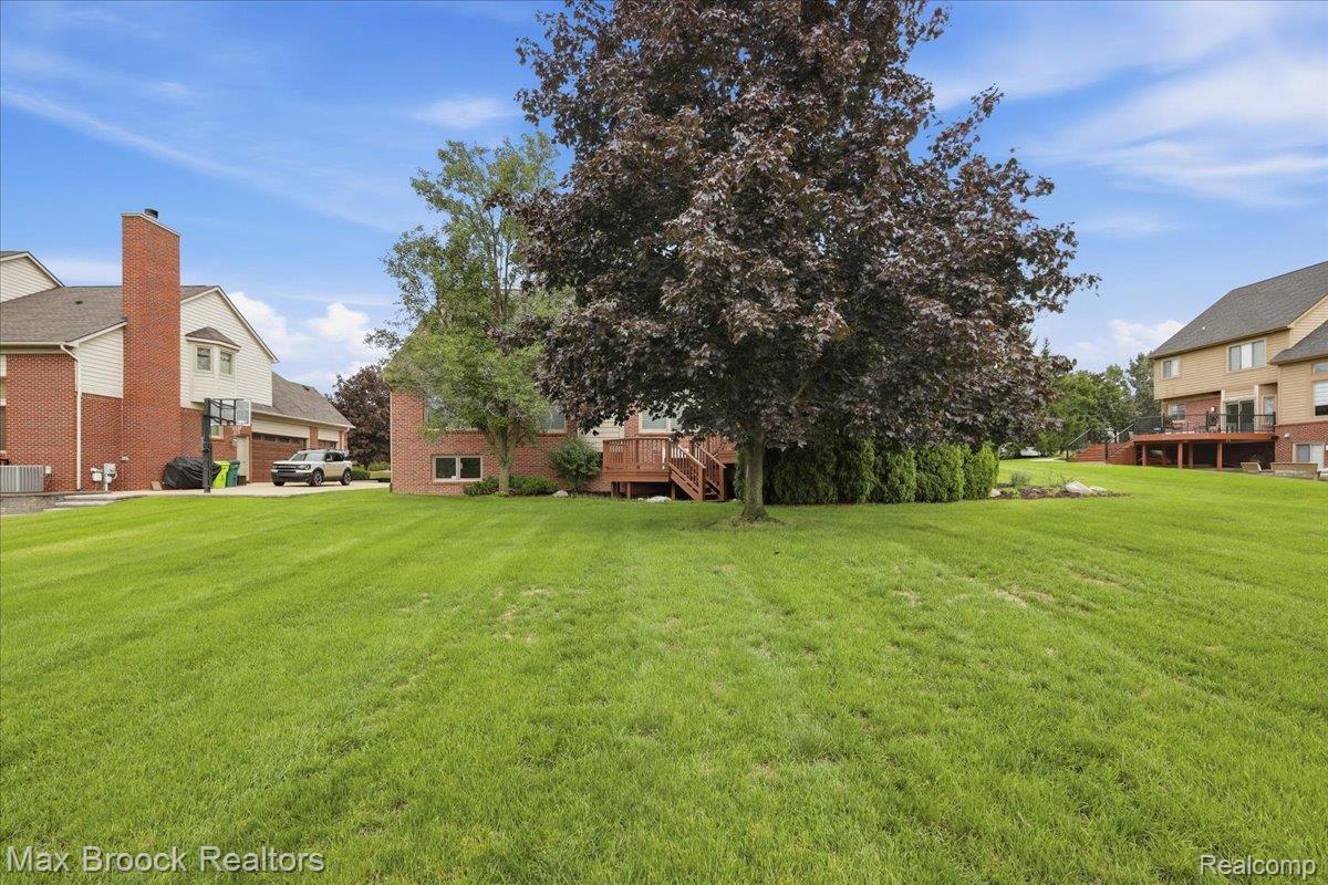 1731 Rico Road Commerce Township, MI 48382 - Photo 47 of 48 Expansive green lawn with mature trees and a multi-level wood deck