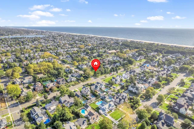 an aerial view of residential houses with outdoor space and swimming pool