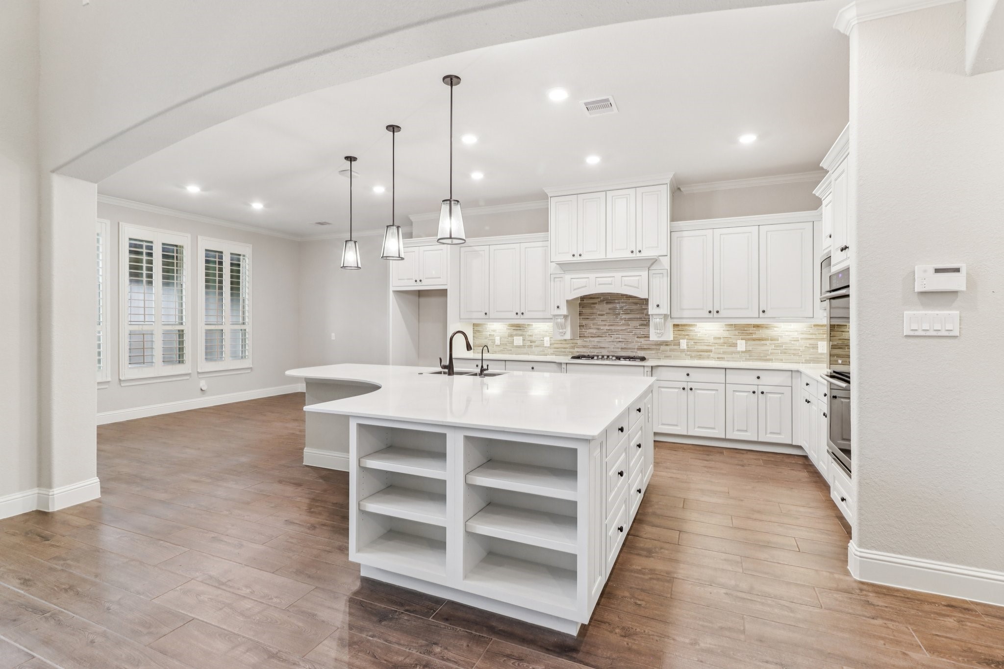 15519 Patten Forest Drive Cypress, TX 77429 - Photo 11 of 46 a open kitchen with kitchen island a sink stainless steel appliances and cabinets