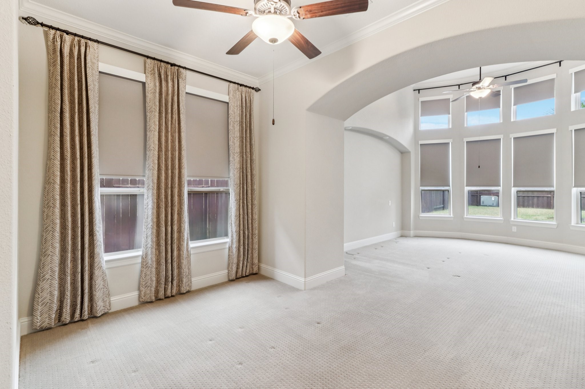 15519 Patten Forest Drive Cypress, TX 77429 - Photo 17 of 46 an empty room with windows chandelier fan and windows