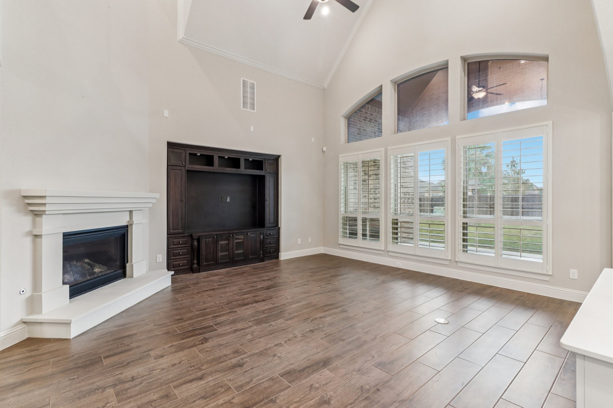 15519 Patten Forest Drive Cypress, TX 77429 - Photo 7 of 46 a view of an empty room with wooden floor fireplace and a window