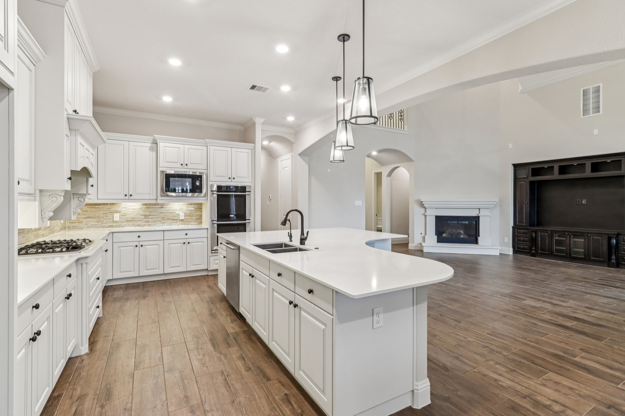 15519 Patten Forest Drive Cypress, TX 77429 - Photo 9 of 46 a large white kitchen with a large island oven a sink stainless steel appliances and cabinets