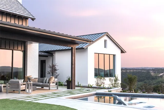 a front view of a house with swimming pool and porch