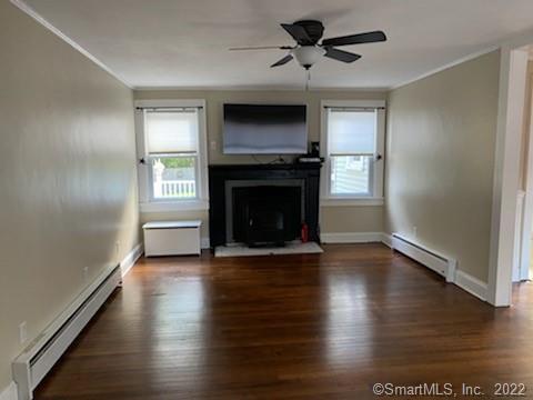 3 Maxson Road Groton, CT 06340 - Photo 5 of 15 an empty room with wooden floor fireplace and windows