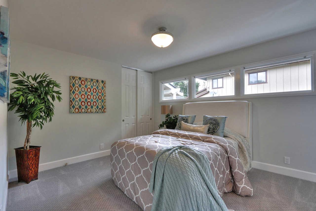 1350 Phyllis Avenue Mountain View, CA 94040 - Photo 18 of 27 a bedroom with a bed and a potted plant