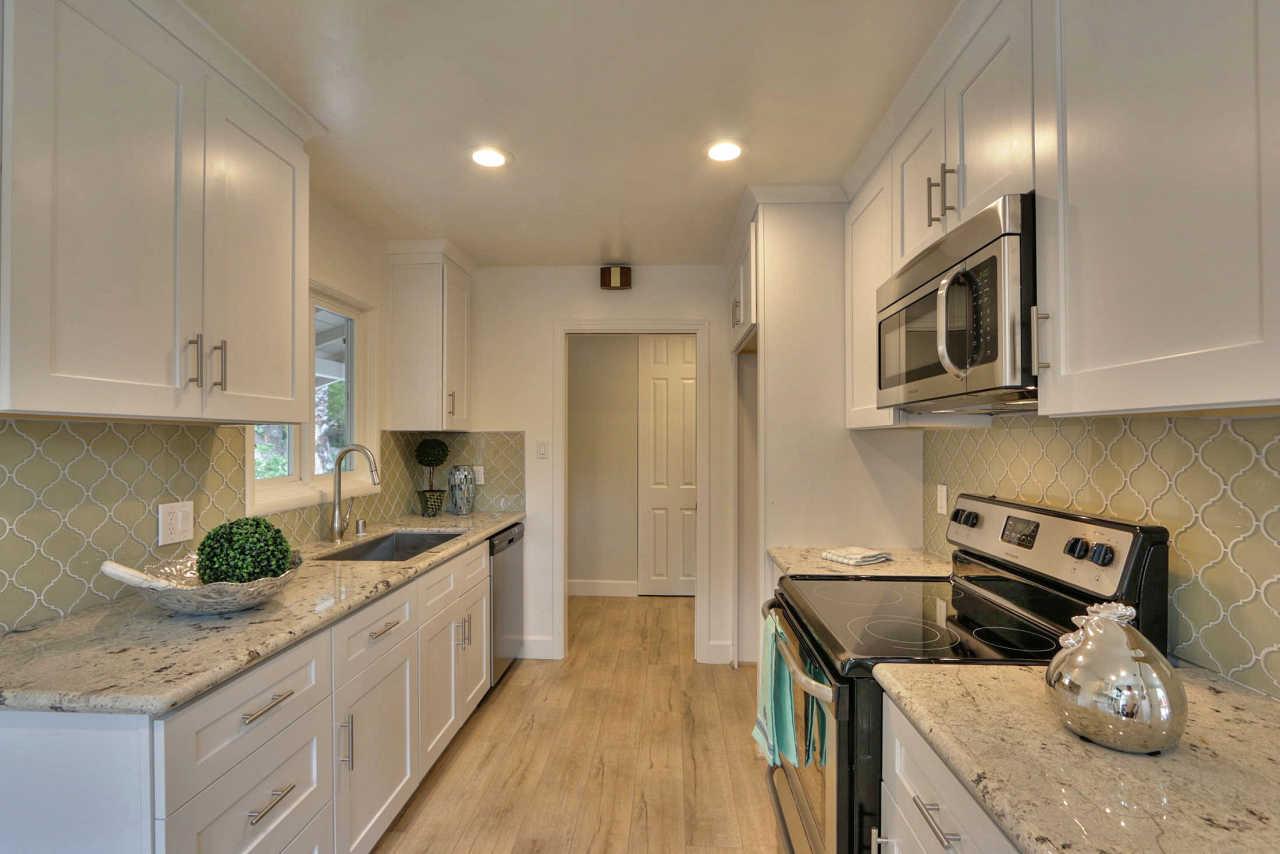 1350 Phyllis Avenue Mountain View, CA 94040 - Photo 6 of 27 a kitchen with stainless steel appliances granite countertop a stove a sink and a microwave