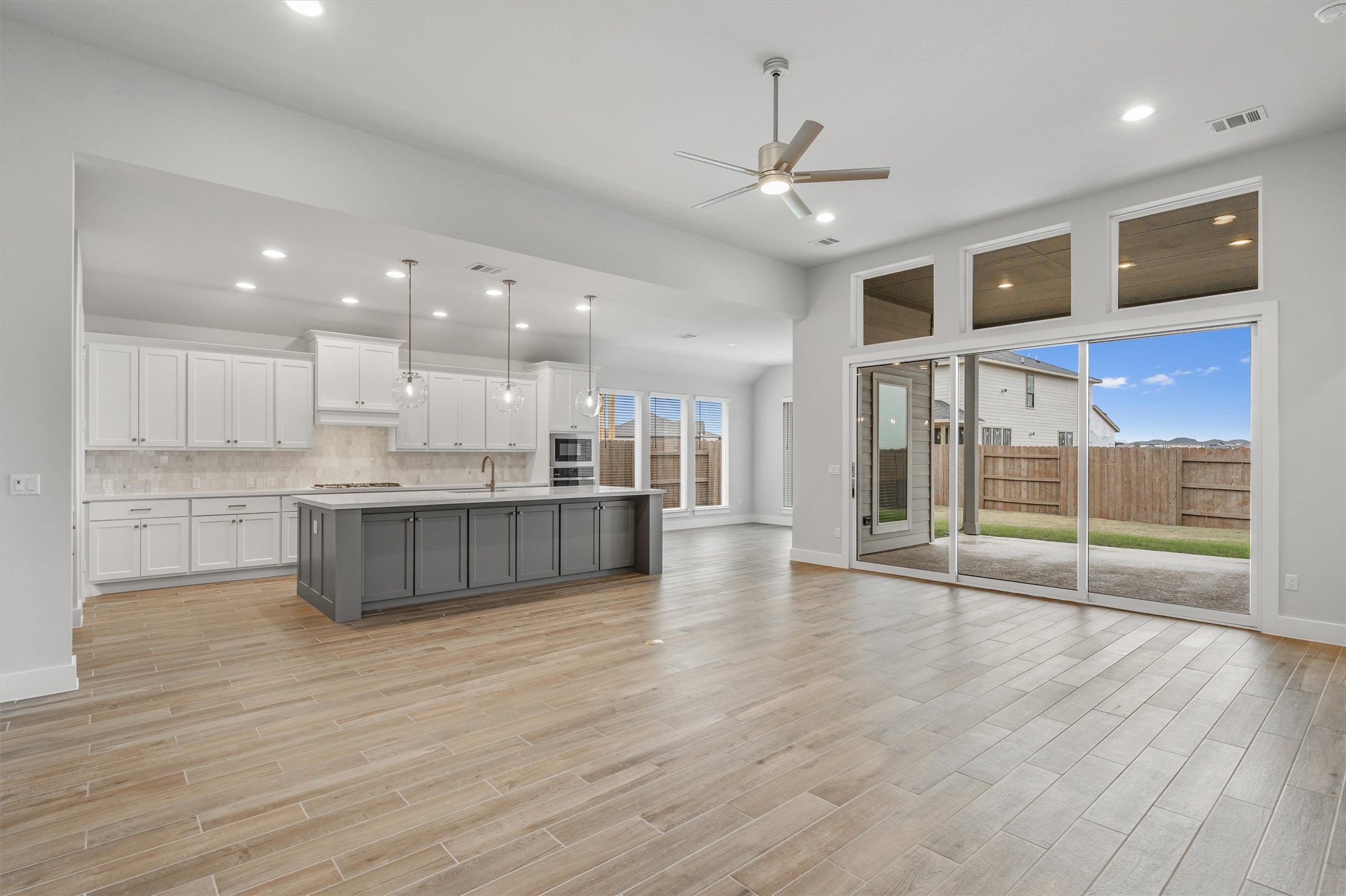 8516 Picnic House Path Austin, TX 78744 - Photo 38 of 39 a large kitchen with stainless steel appliances granite countertop a large counter top a sink and a chandelier