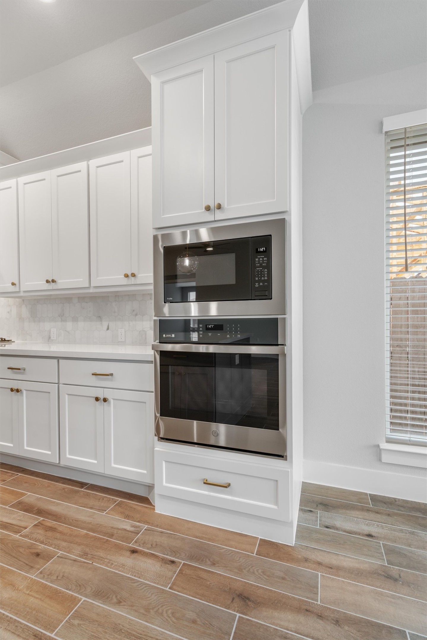 8516 Picnic House Path Austin, TX 78744 - Photo 12 of 39 a kitchen with granite countertop white cabinets and stainless steel appliances