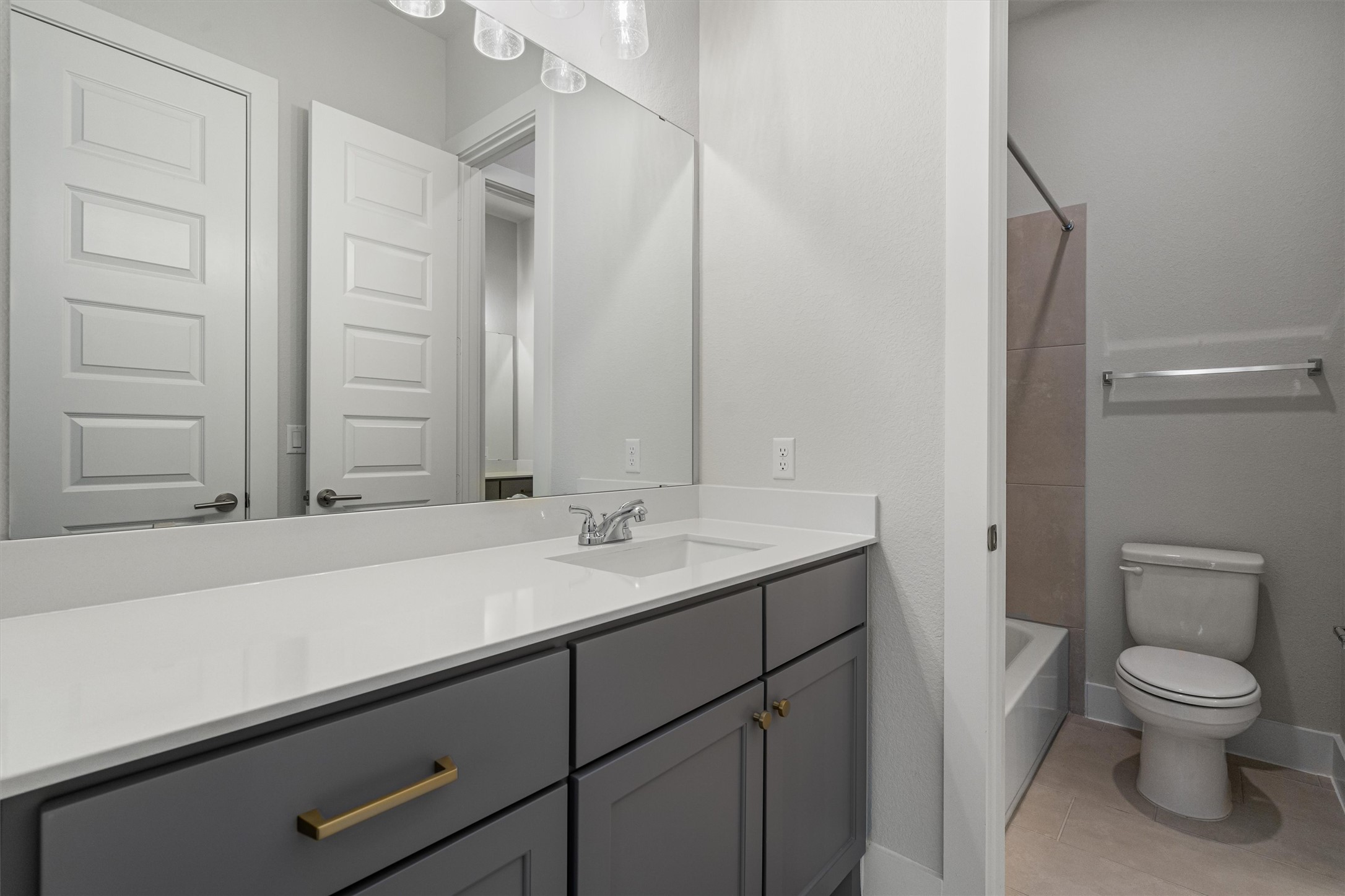 8516 Picnic House Path Austin, TX 78744 - Photo 24 of 39 a bathroom with a granite countertop sink a toilet and a mirror