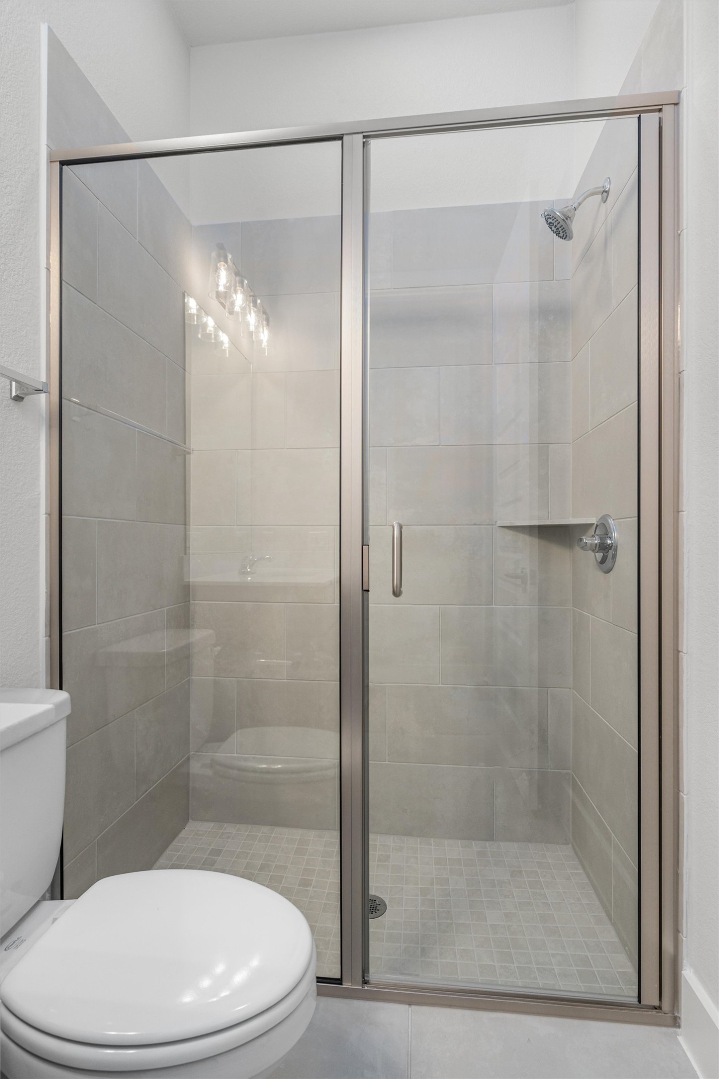 8516 Picnic House Path Austin, TX 78744 - Photo 33 of 39 a bathroom with a shower a toilet and a glass window