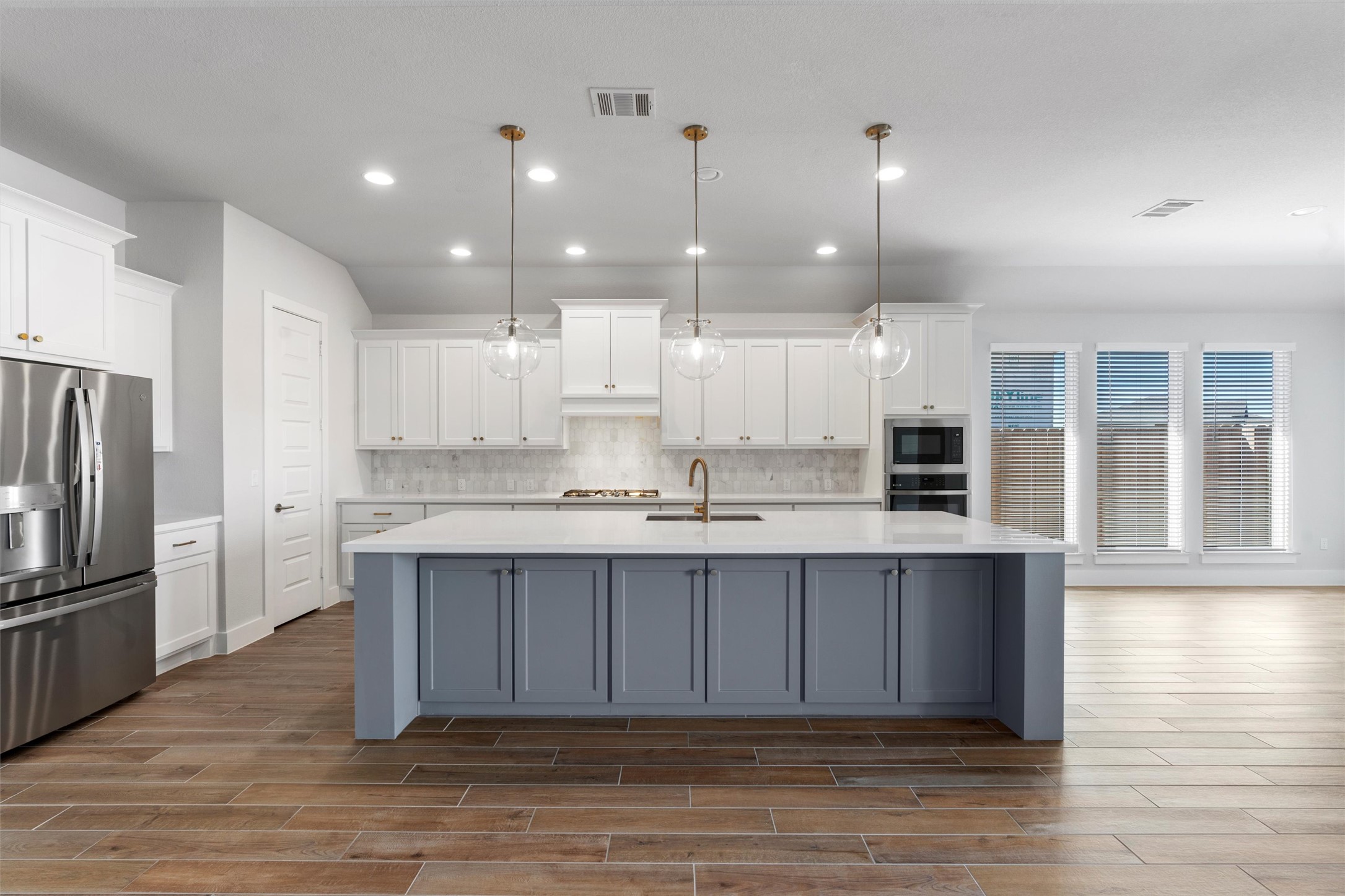 8516 Picnic House Path Austin, TX 78744 - Photo 4 of 39 a large kitchen with kitchen island a sink stainless steel appliances and cabinets