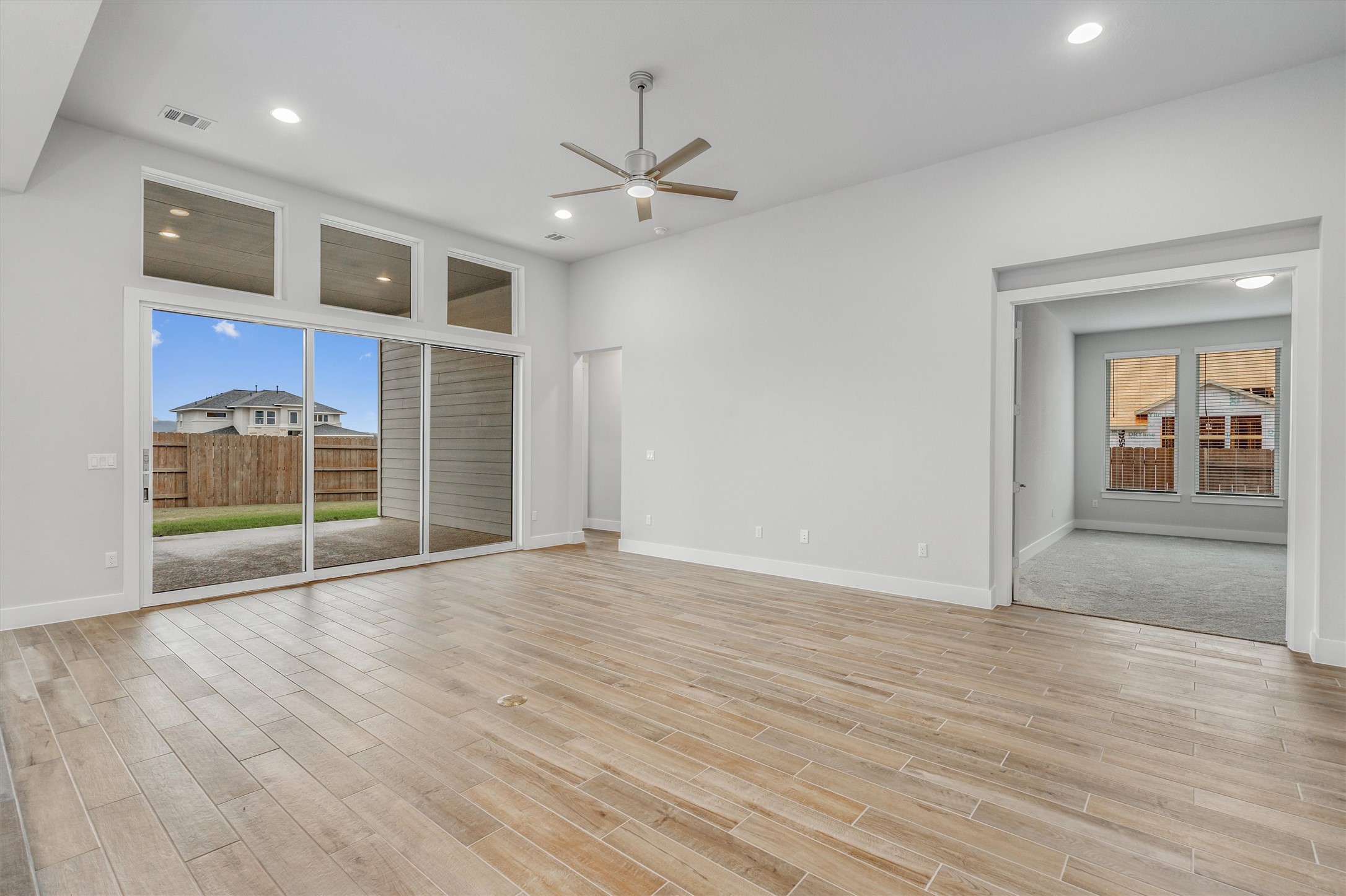 8516 Picnic House Path Austin, TX 78744 - Photo 10 of 39 a view of empty room with wooden floor and fan