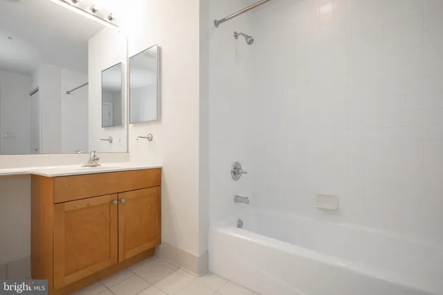 a view of a hallway with wooden floor and furniture