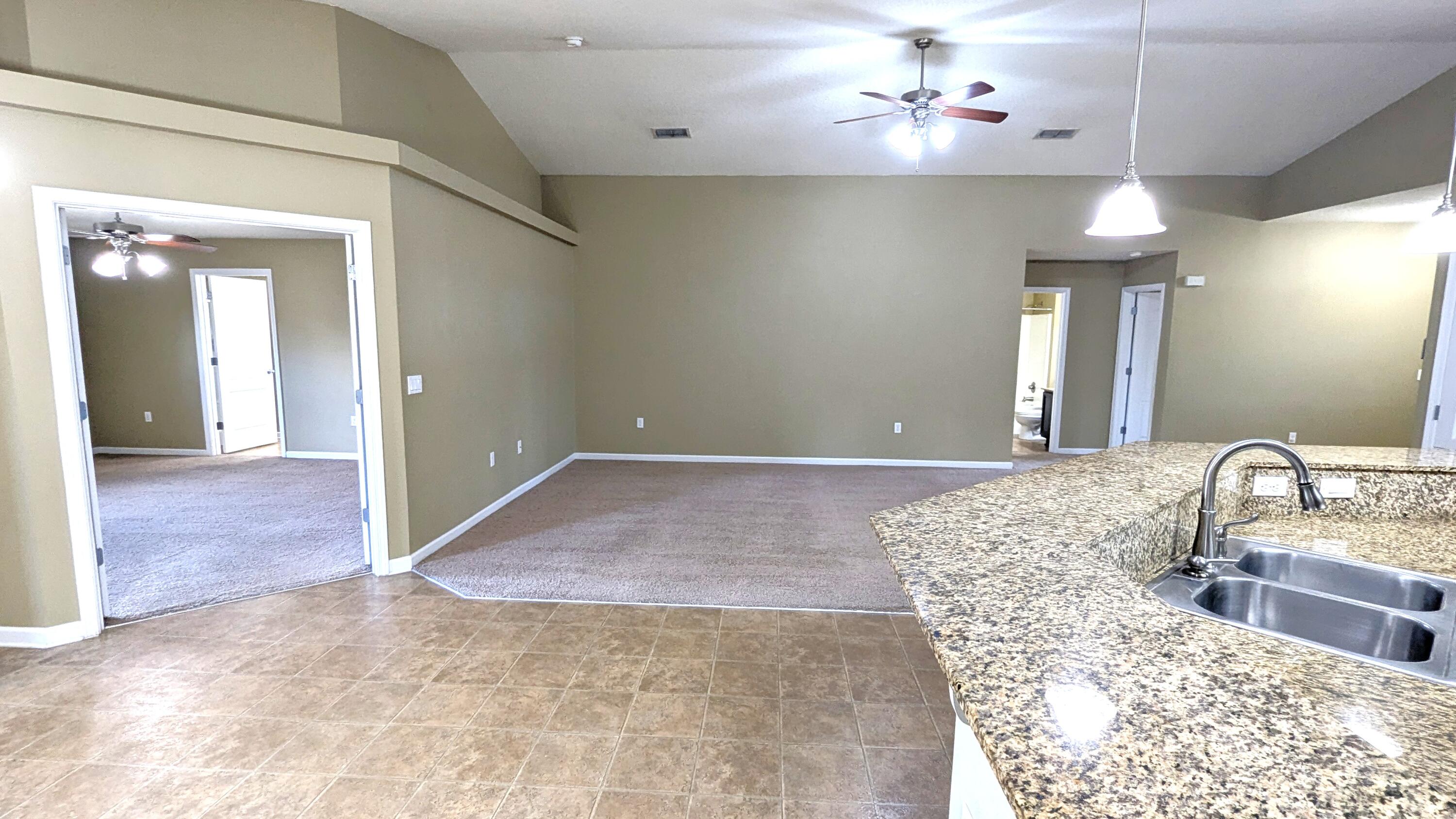 7976 Promise Creek Road Navarre, FL 32566 - Photo 12 of 29 a spacious bathroom with a granite countertop sink a light fixture and a mirror