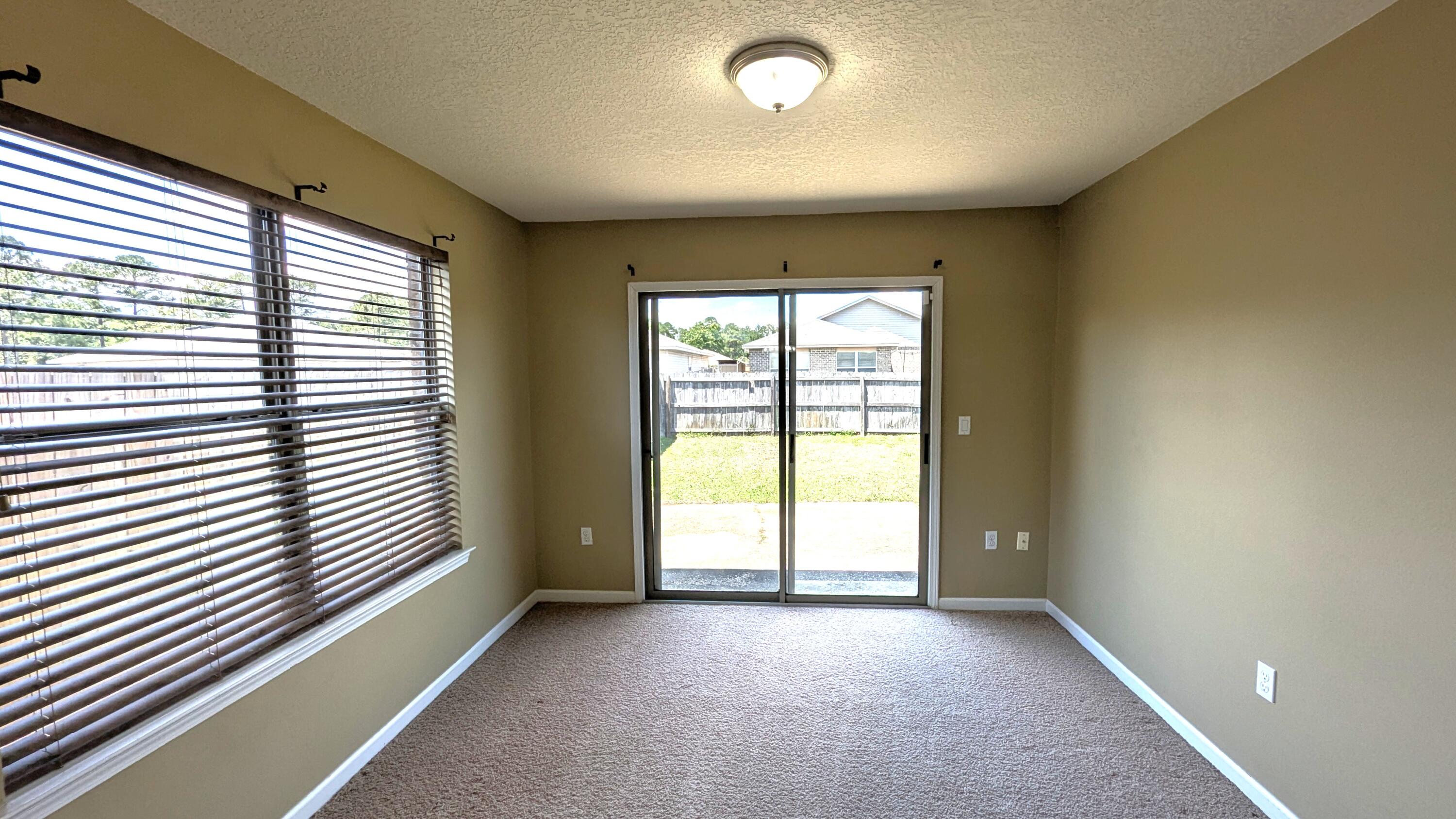 7976 Promise Creek Road Navarre, FL 32566 - Photo 17 of 29 a view of an empty room with a window