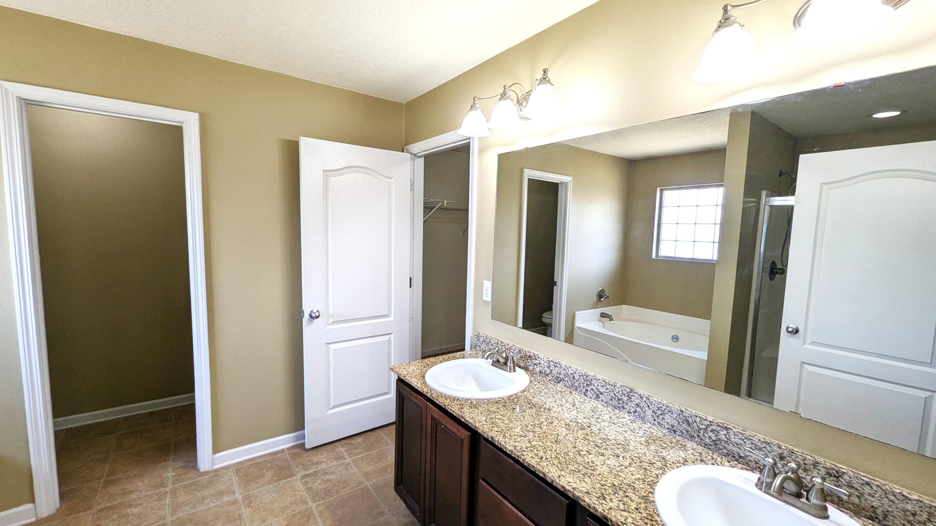 7976 Promise Creek Road Navarre, FL 32566 - Photo 22 of 29 a bathroom with a granite countertop sink and a mirror