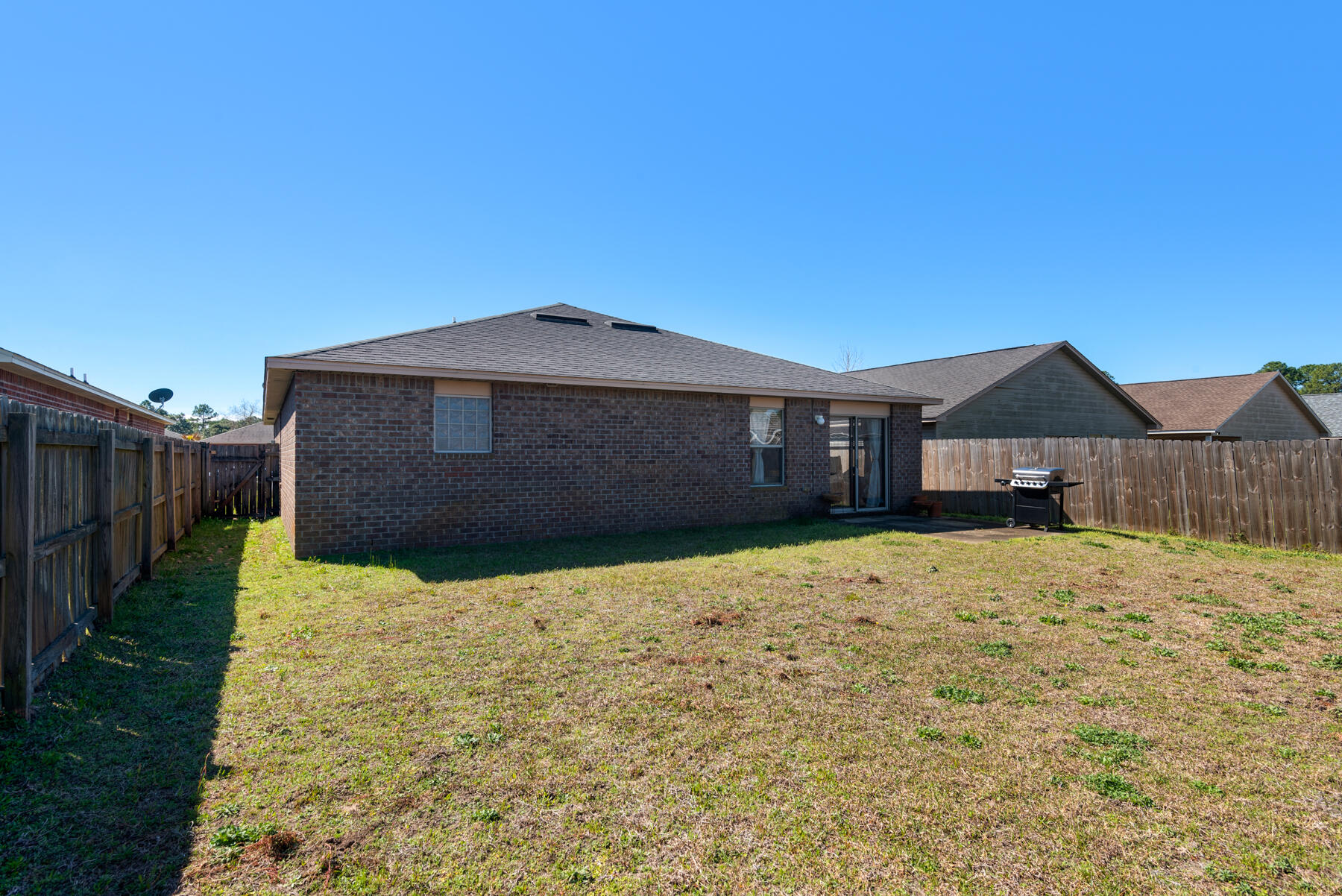 7976 Promise Creek Road Navarre, FL 32566 - Photo 28 of 29 a front view of a house with a yard