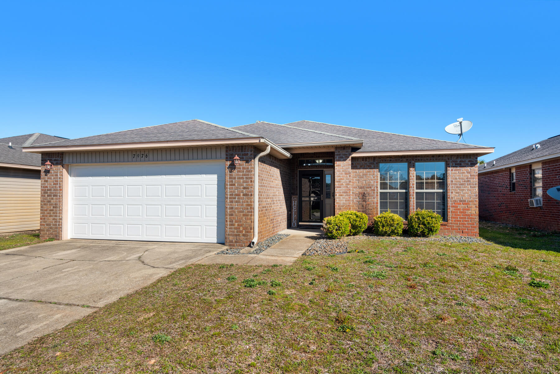 7976 Promise Creek Road Navarre, FL 32566 - Photo 5 of 29 a front view of a house with a yard and garage