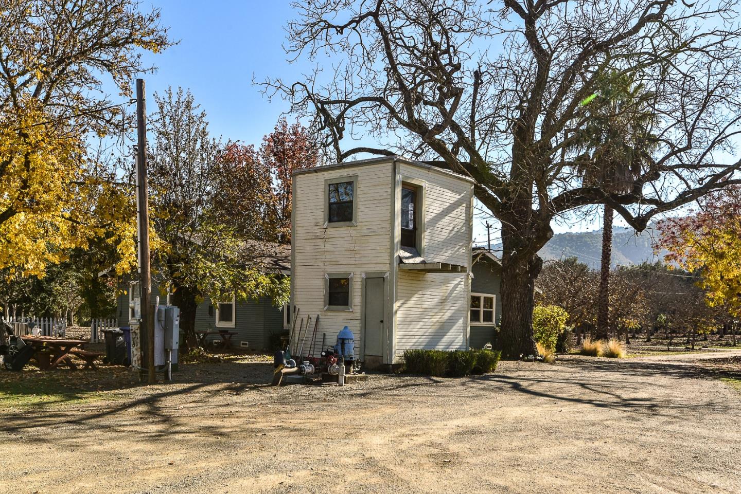 3385 Hecker Pass Road Gilroy, CA 95020 - Photo 17 of 18 a white house that has a tree in front of it